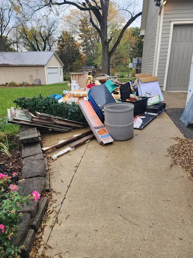 Dumpster being loaded with debris for Estate Cleanout Dumpster Rental in Lynwood